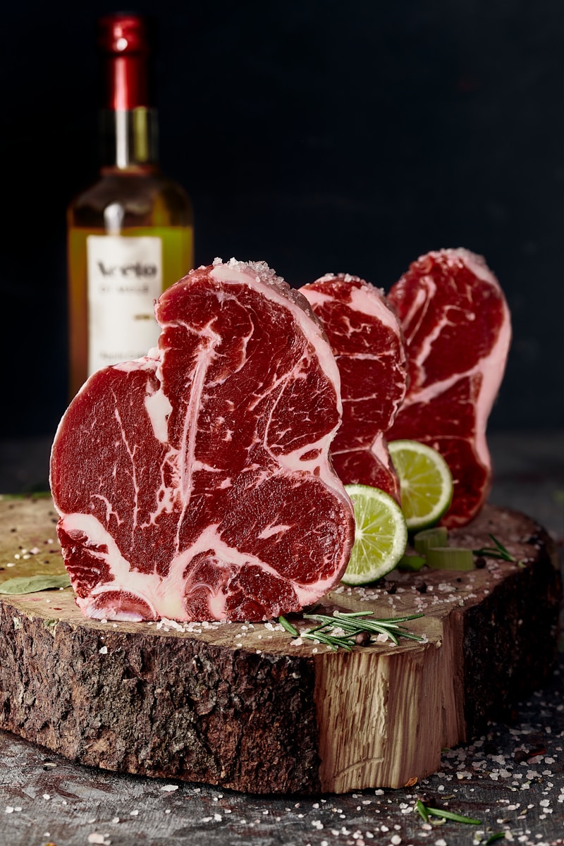 raw meat on brown wooden chopping board